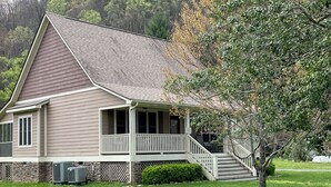 A single-story house with a front porch, a staircase leading to the entrance, and a well-maintained lawn.