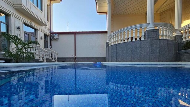 A swimming pool with a tiled floor and a balustrade on one side. - Oscar Hotel (Samarkand)