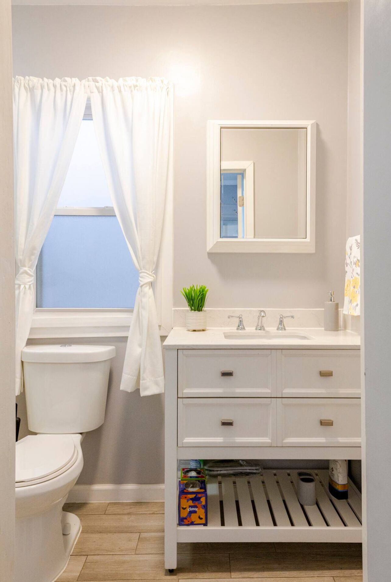 Une salle de bain avec des toilettes, un lavabo et un miroir.