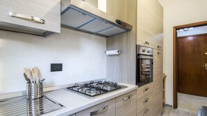 A modern kitchen with a gas stove, oven, and stainless steel appliances.