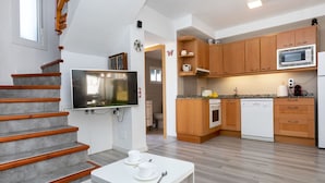 Een moderne keuken met houten kastjes, een magnetron en een vaatwasser.