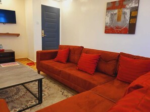 Luxury Penthouse, 1 King Bed, Non Smoking, Hill View | Living area | Smart TV, toys - Comfort E Suites (Kiserian)