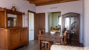 A dining area with a wooden table, chairs, and a cabinet.
