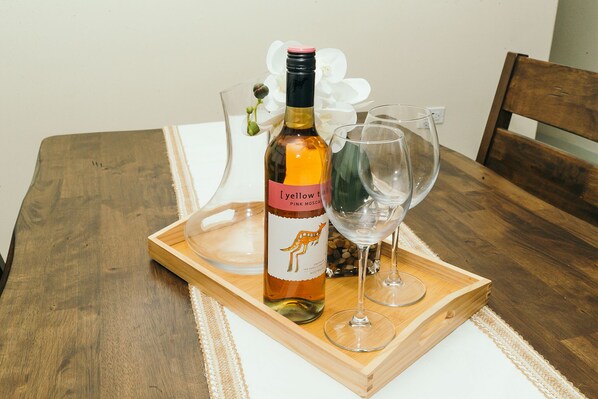 A bottle of wine on a wooden tray with two glasses. - Your cool oasis home away from home. Breath taking views for relaxation  (Ocho Rios)