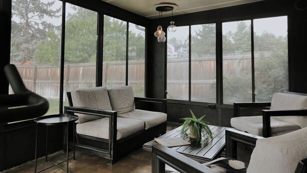 A modern living room with a sofa, chairs, a coffee table, and a potted plant. - Cozy 3BR Home with AC, Hot Tub & Walkable Restaurants (Wheat Ridge)