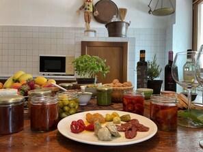 A kitchen counter with various food items, jars, and a plate of food. - Beautiful  villa for 6 guests with WIFI, A/C, TV and patio (Lucinasco)