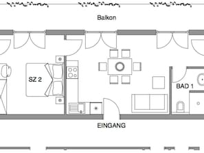 Un plan d’étage d’une chambre d’hôtel comprenant un balcon, une kitchenette, un coin repas et une salle de bain.