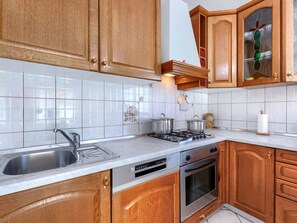 Enjoy cooking and dining in this well-equipped kitchen with a stove, oven, and dishwasher.
