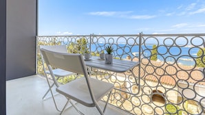 A balcony with a white metal railing, a white folding chair, a small table, and a potted plant. - Beautiful private villa for 8 guests with WIFI, private pool, A/C, TV and terrace (Roses)