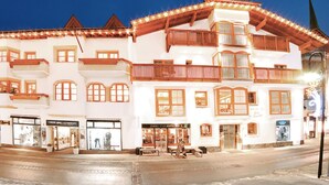 A multi-story building with a traditional architectural style, featuring balconies and large windows.