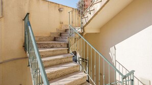 A set of outdoor stone steps with metal railings, leading up to a building entrance. - Beautiful apartment for 6 guests with WIFI, A/C, TV and terrace (San Vito Lo Capo)