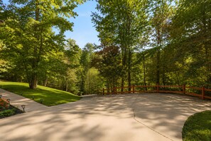 A paved pathway in a park with a wooden fence and trees. - Cardinal's Nest • Sleeps 10 • Near Dollywood, Pigeon Forge & Gatlinburg (Sevierville)