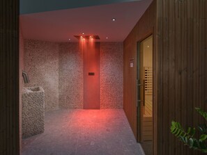Features a stone wall design, wooden door, and a cozy seating area with a bench.