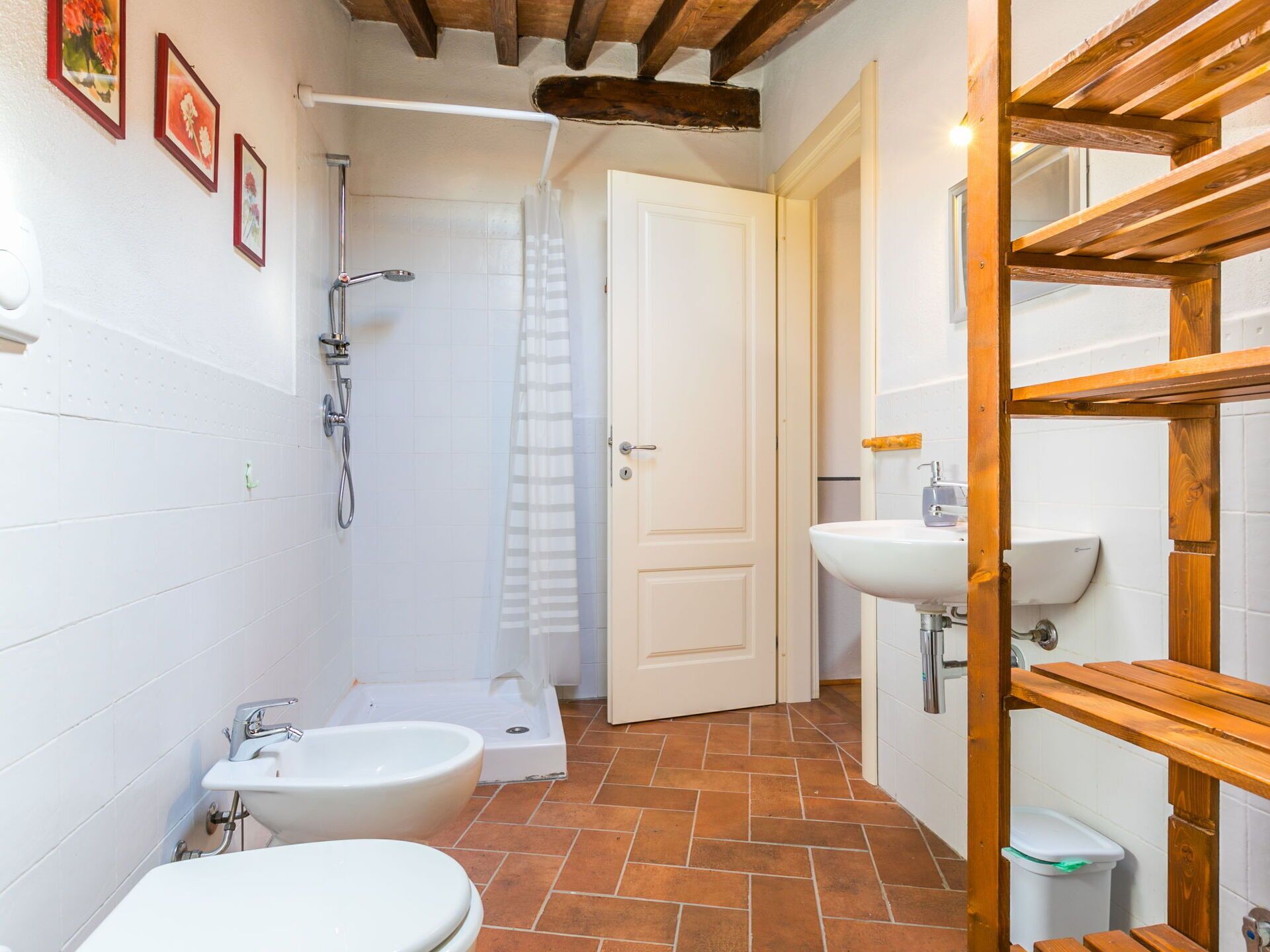 A compact bathroom with a shower, two sinks, and a toilet.