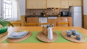 A compact kitchen with wooden cabinets, a dishwasher, a microwave, and a refrigerator. - Wonderful private villa for 7 guests with WIFI, A/C, TV and pets allowed (Amposta)