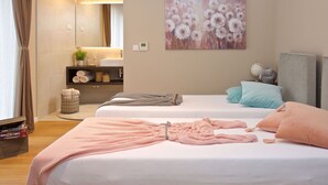 A hotel room with two beds, a large mirror, a painting of flowers, and a small plant on the vanity. - Beautiful private villa with A/C, WIFI, hot tub, private pool, TV, terrace and pets allowed (Umag)