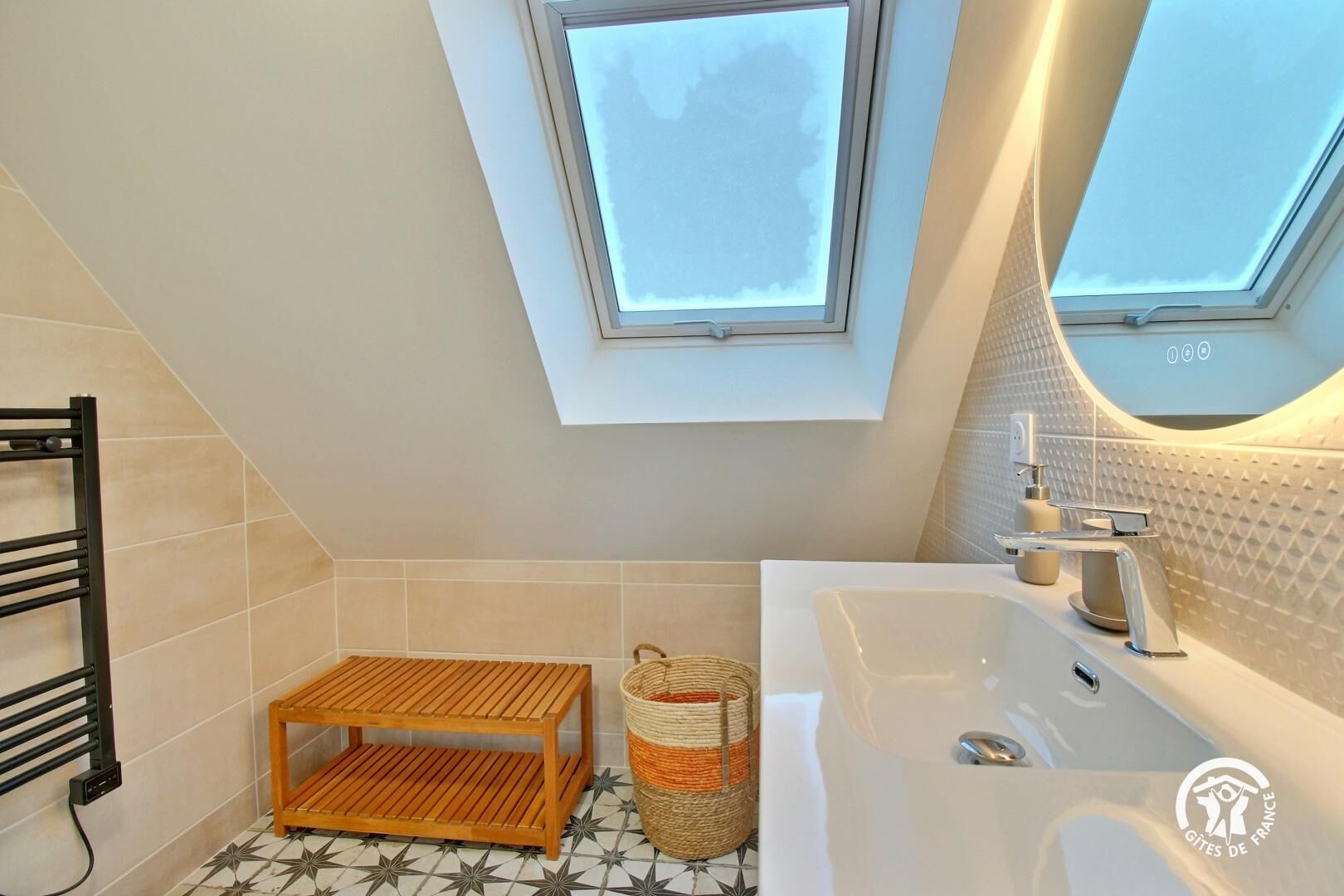 A modern bathroom with a skylight, a bathtub, a wooden shelf, and a woven basket.