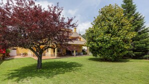 A house with a well-maintained lawn, a patio, and a large tree in the foreground. - Country House with Garden, Near Barcelona and with Sea Views (Sant Andreu de Llavaneres)