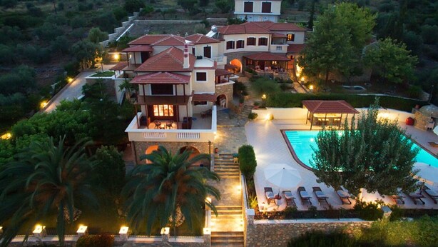 A large, multi-story house with a swimming pool, surrounded by lush greenery and hills. - Villa 'Beach  Alonissos For 6 People' with Shared Pool, Wi-Fi and Air Conditioning (Alonissos)