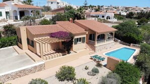 A residential property with a swimming pool, outdoor seating, and a garden. - Villa 'Diana' with Private Pool, Wi-Fi and Air Conditioning (Cala en Porter)
