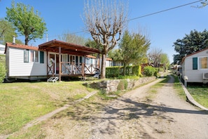 A row of mobile homes with a gravel path between them.