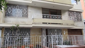 A multi-story residential building with barred windows and balconies. - Gold Stadium (Medellín)