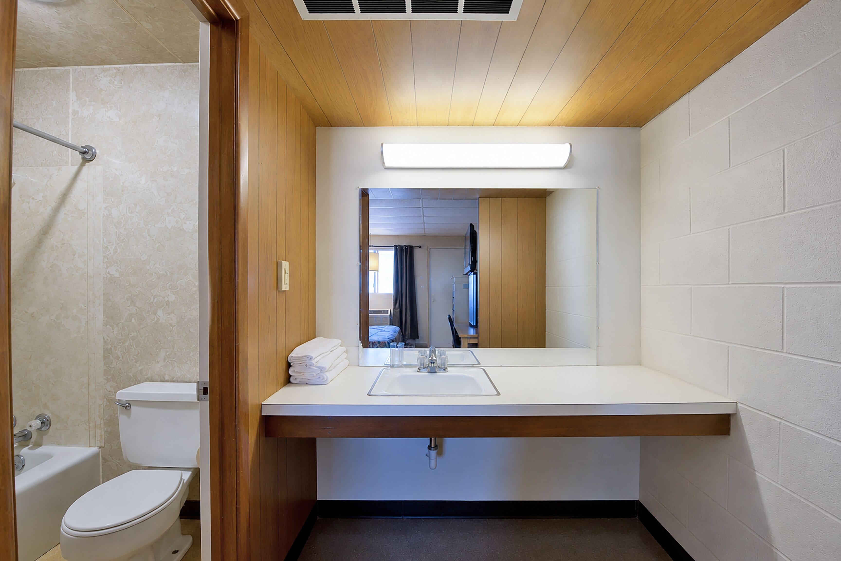 A modern bathroom with a toilet, sink, and shower.