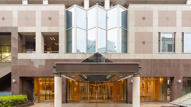 A modern building entrance with a glass facade, a central elevator, and a covered entrance area. - The OneFive Osaka Namba Dotonbori (Osaka)
