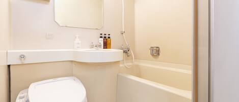 A modern bathroom with a toilet, sink, and bathtub.