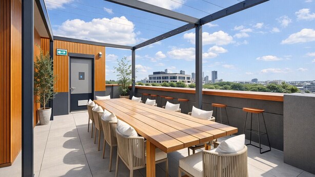 An outdoor terrace with a long wooden table and chairs, a potted plant, and a city view. - Modern, Industrial Hideaway (Collingwood)