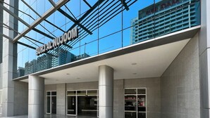 A modern building with a glass facade and the sign "BURJAL NUSJOM" indicating it is a hotel.