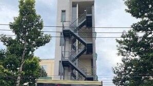 A hotel named "KHÃCH SAN HOÃNG GIA" with a visible entrance and a staircase leading to an upper floor. - Hoang Gia Hotel Binh Duong by Bay Luxury (Ho Chi Minh City)