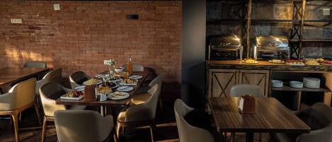 A restaurant with brick walls, wooden tables, and chairs.
