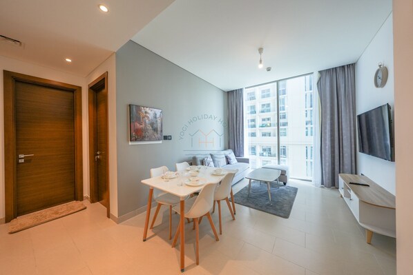 Comfort Apartment | Living area | 65-inch Smart TV with cable channels - Yogi - Unwind in this 1BR at Sobha Creek Vistas Reserve (Dubai)