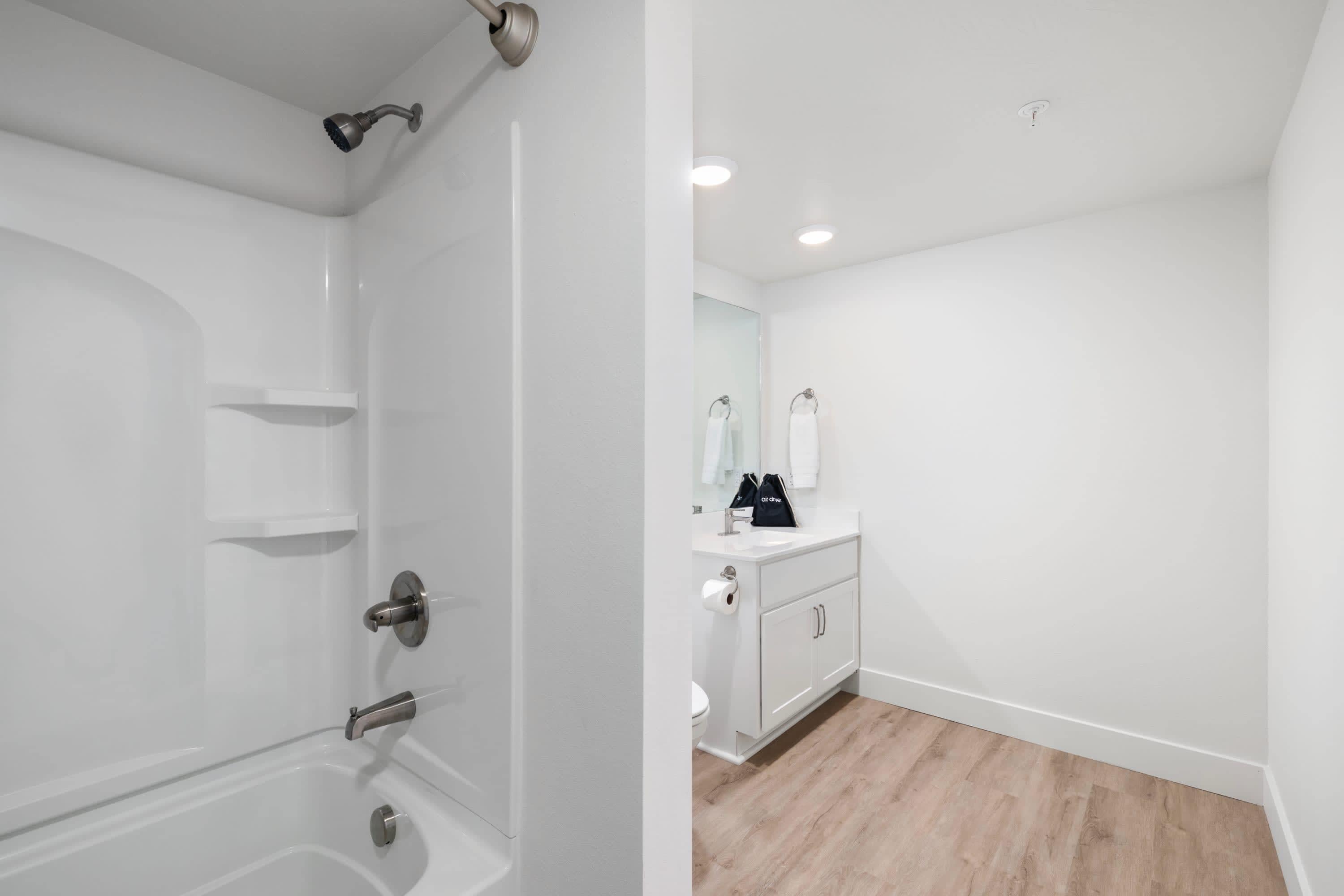 A bathroom with a bathtub, a toilet, and a sink.