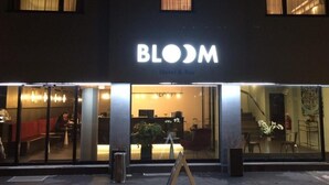 A hotel named "BLOOM" with a modern interior visible through the glass doors. - BLOOM Boutique Hotel & Lounge Basel (Basel)