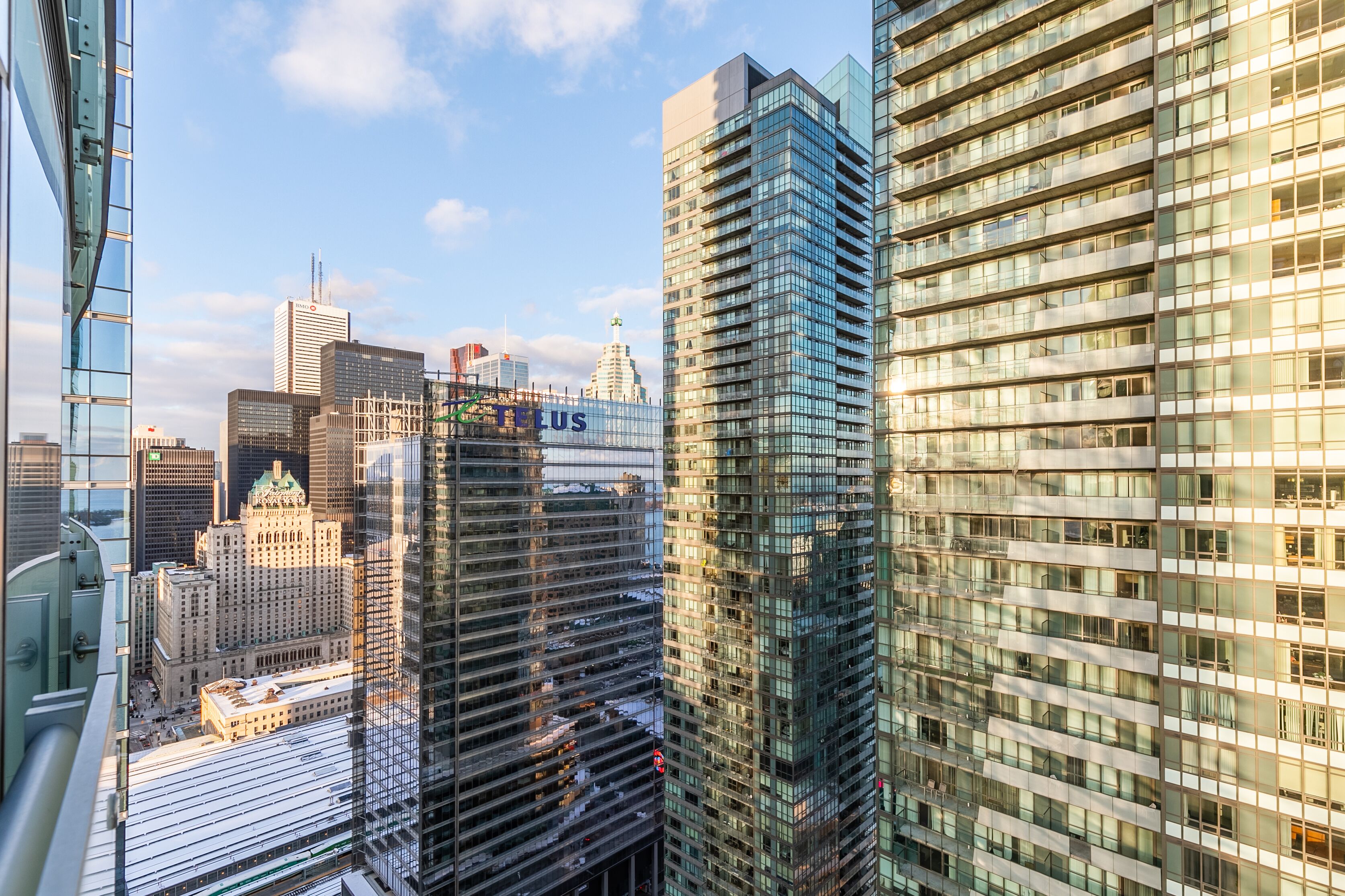A high-rise building with a glass facade and a visible 'US' sign on the top.