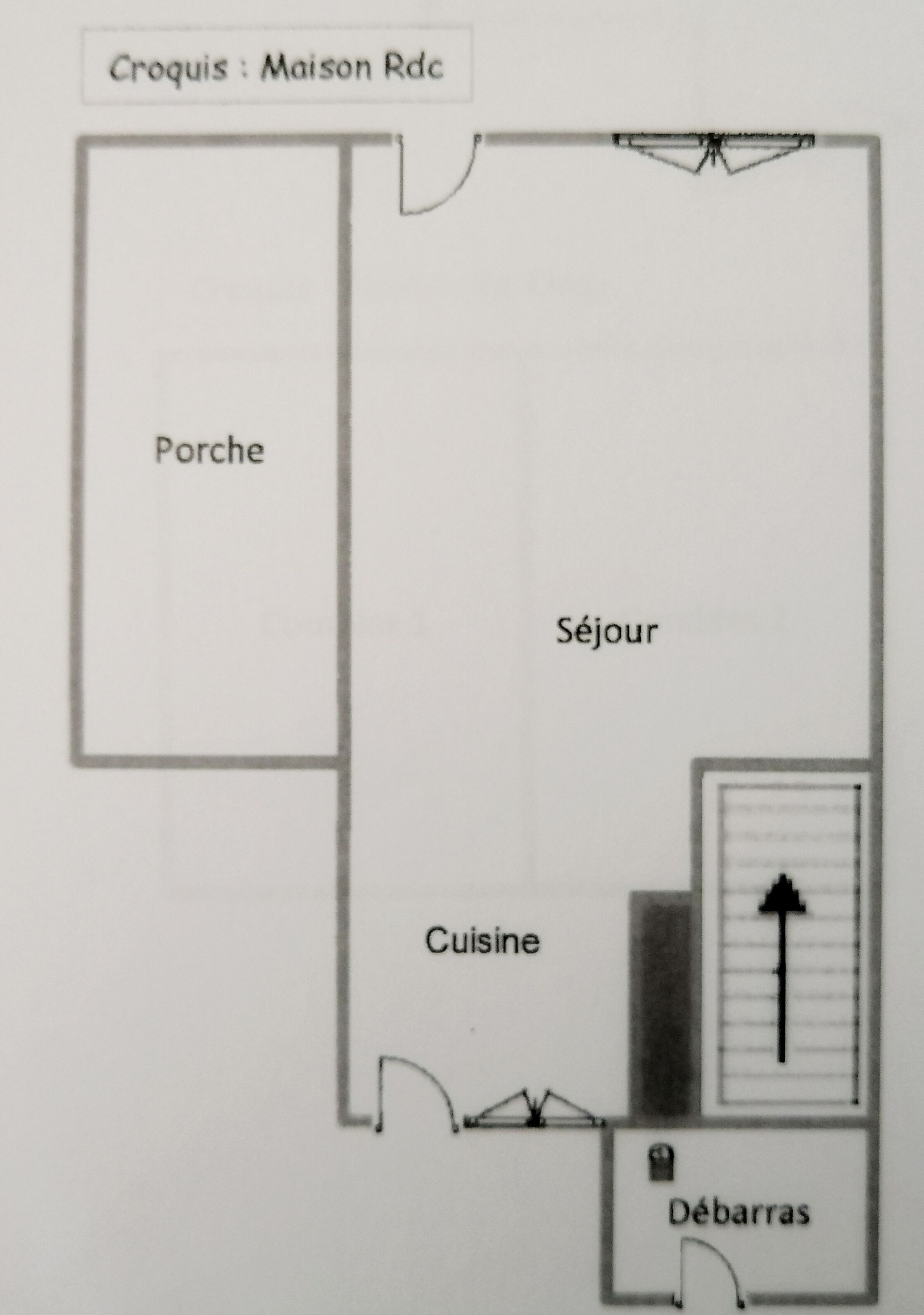 A floor plan of a maison with labeled rooms: Porche, Séjour, Cuisine, and Débarras.