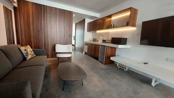 Una sala de estar moderna con un sofá, una mesa de centro y un televisor.