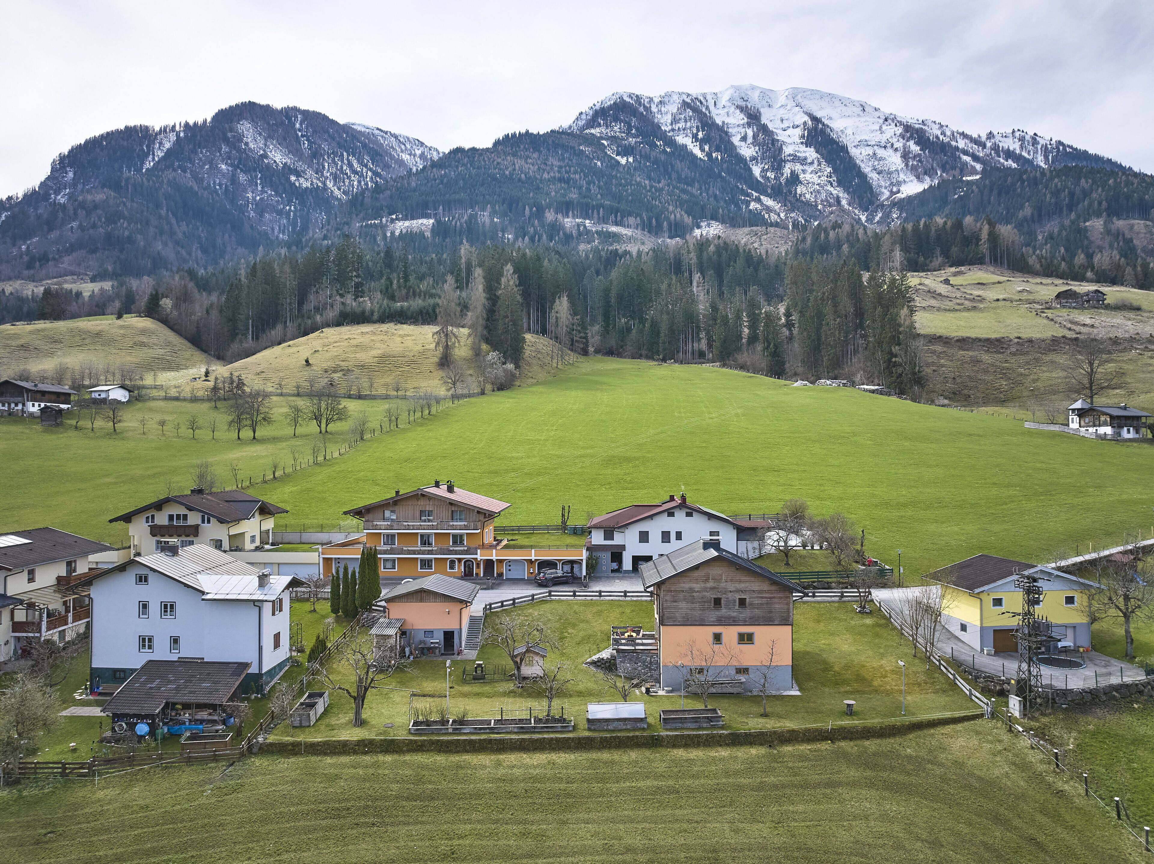 A rural village with houses and a mountain backdrop.