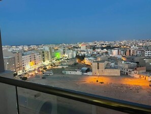 A cityscape viewed from a high vantage point, likely from a hotel window.