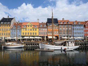 A harbor with colorful buildings and boats docked.