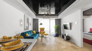 Superior Apartment, Sea View | Living area | 65-inch Smart TV with cable channels, heated floors