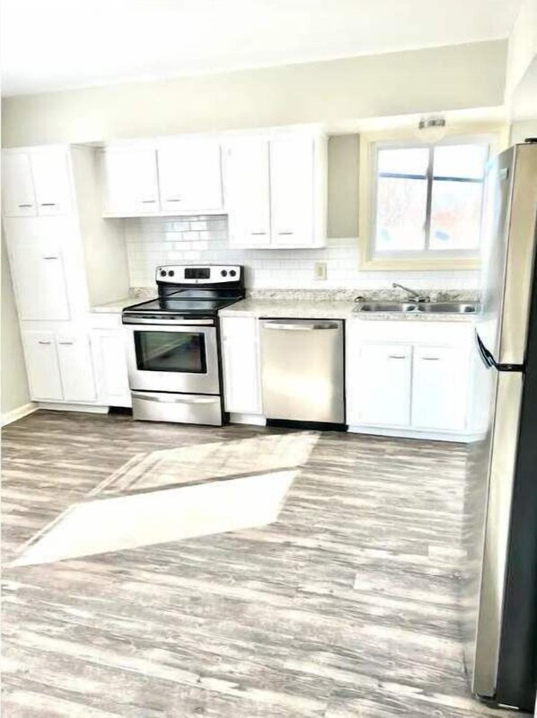 Enjoy cooking in this well-equipped kitchen with a stove, oven, and dishwasher.