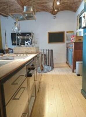 Enjoy cooking in this well-equipped kitchen with a stainless steel sink and range hood.