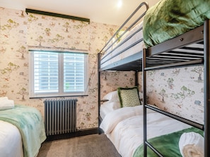 A bunk bed room with a radiator, a window with blinds, and wallpaper with a nature theme. - Perfect for a special occasion or get-together. (Medstead, near Alton)
