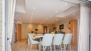 A modern kitchen with a dining area, wooden flooring, and a clock on the wall. - Perfect for a special occasion or get-together. (Medstead, near Alton)