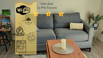 A modern living room with a grey sofa, a wooden coffee table, and a decorative vase.