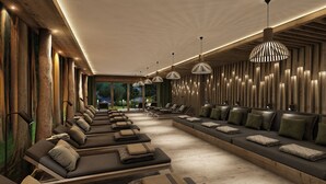 A modern spa area with multiple massage tables, ambient lighting, and a view of a natural landscape. - Das Förstereck (Viehhofen)
