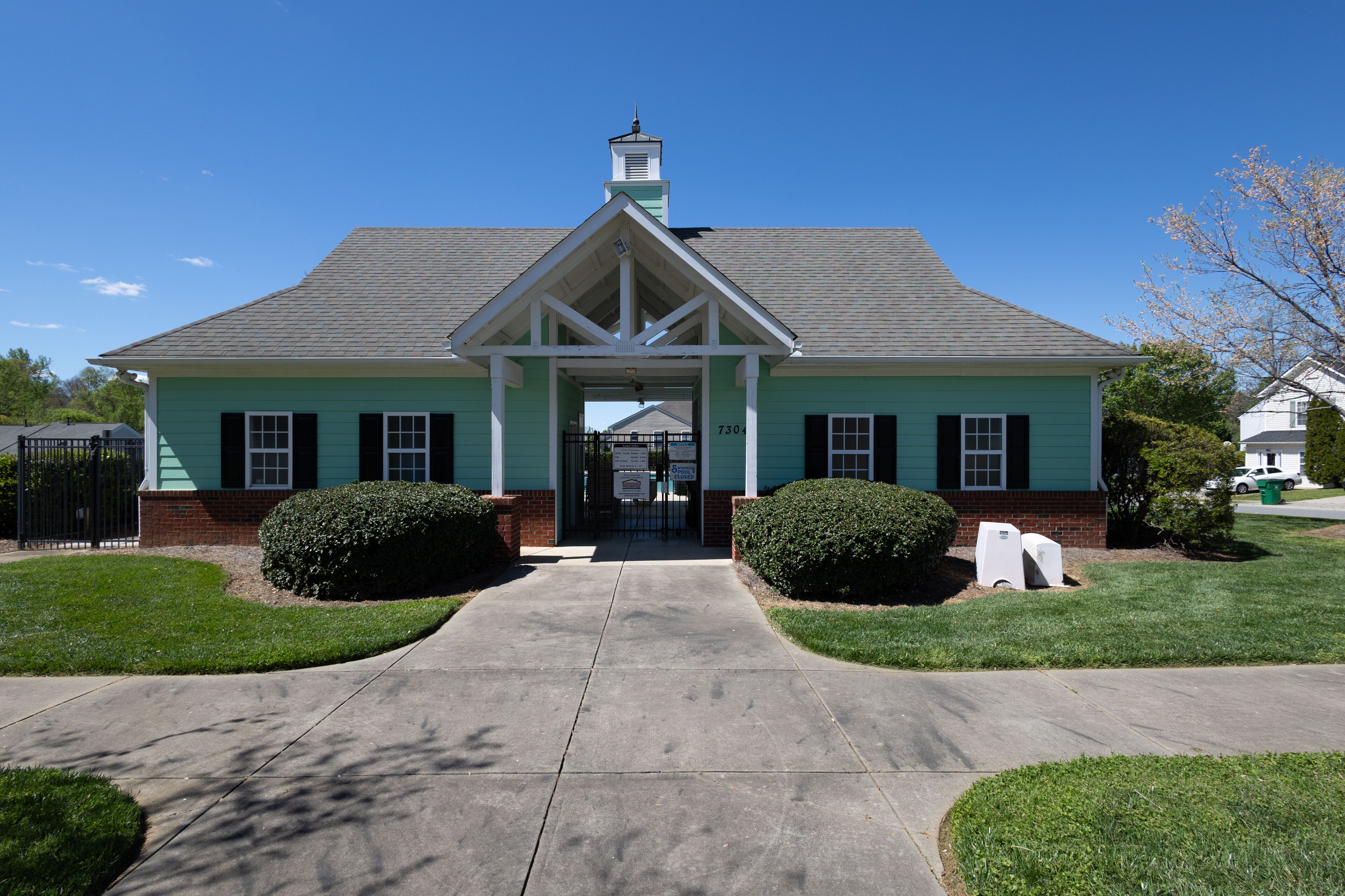 A two-story building with a gabled roof and a central entrance.